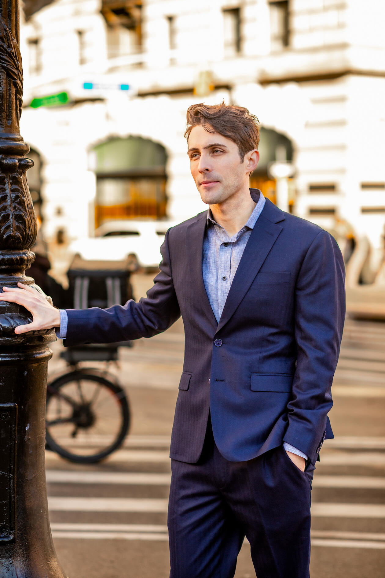 Image of Corey Birnstengel leaning against a lamp pole in NYC